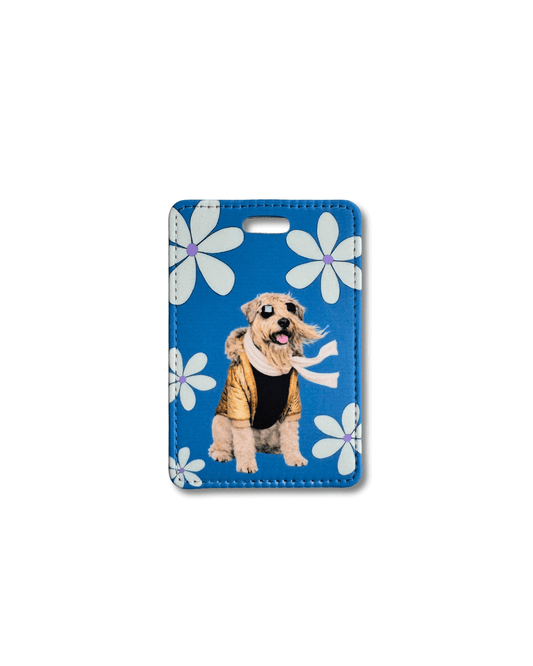 funny wheaten terrier luggage tag; tan soft-coated wheaten terrier wearing black glasses, gold jacket, and white scarf on a blue background with white flowers