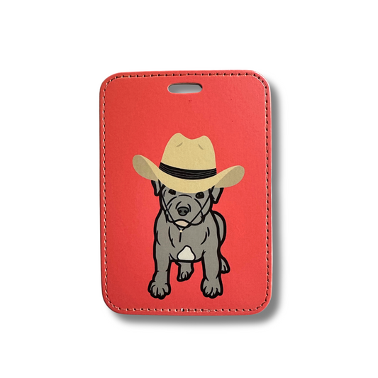 cute gray staffordshire bull terrier puppy wearing a tan cowboy hat on a pit bull themed dog luggage tag. Rec background.