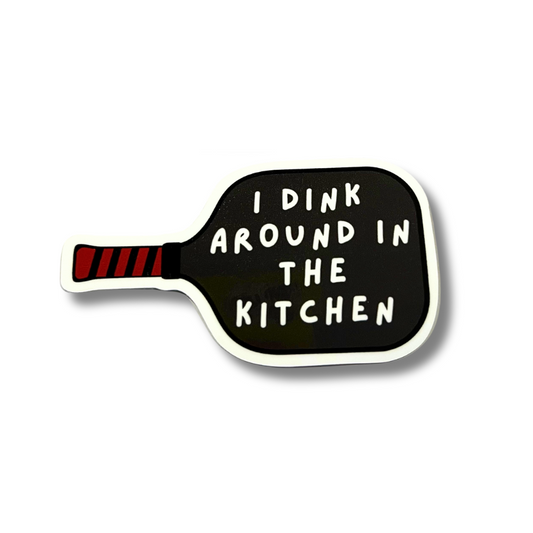 vinyl decal in the shape of a pickleball paddle (black paddle with red and black handle): I dink around in the kitchen.