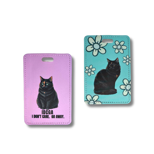 two styles of tortie cat luggage tags, left one is lavender background with text and turquoise with white flowers.