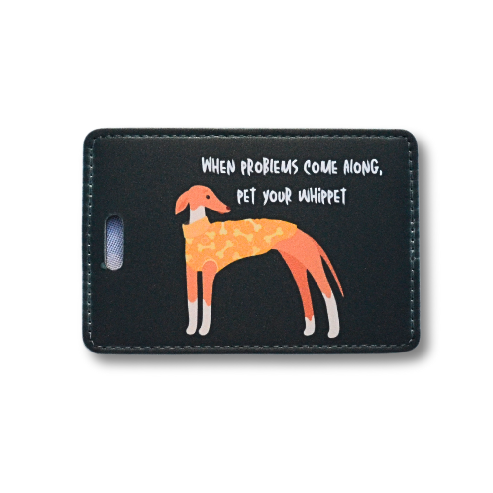 Black background with whippet luggage tag with rust colored whippet dog wearing yellow and orange sweater: When problems come along, pet your whippet.