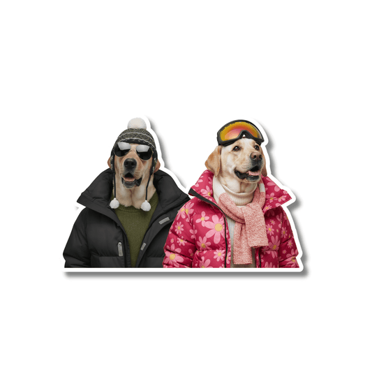 yellow lab ski goggles sticker; two yellow Labradors wearing winter jackets, one with aviator sunglasses and earflap hat and one with mirrored ski goggles and pink floral coat on white background