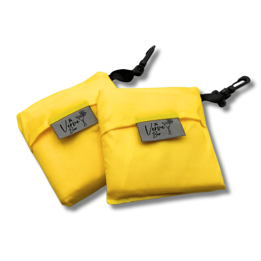 Two yellow folded reusable bags with black straps and 'Verve Bar' labels on a white background